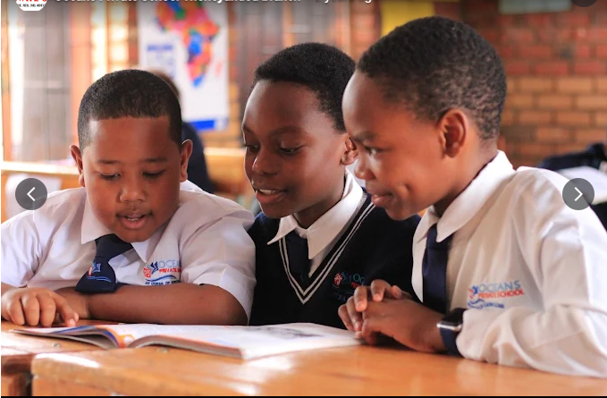 Boys reading at desk in class